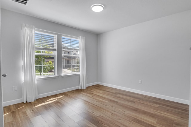 spare room with hardwood / wood-style floors