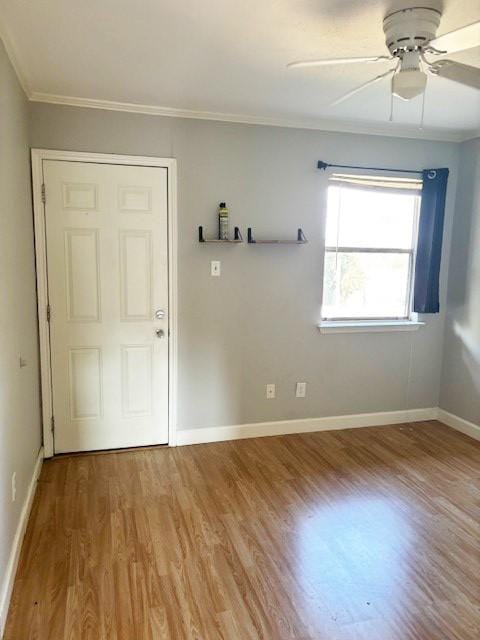 5608 Cougar Dr Unit 219, Austin, TX 78745 - empty room featuring wood finished floors, ornamental molding, ceiling fan, and baseboards