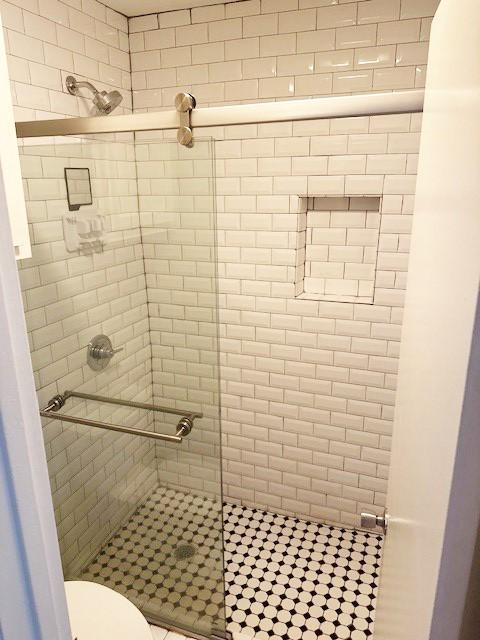 5608 Cougar Dr Unit 219, Austin, TX 78745 - bathroom with a stall shower and toilet