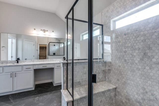 bathroom featuring lofted ceiling, vanity, and an enclosed shower