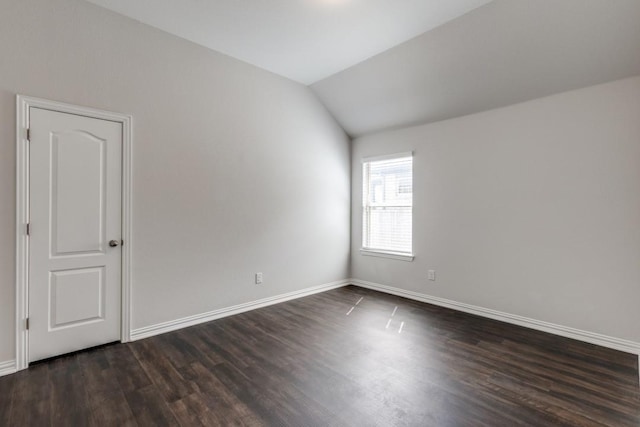 509 Oleander Loop, Buda, TX 78610 - spare room featuring dark wood-style floors, baseboards, and lofted ceiling
