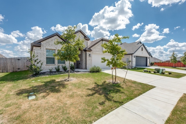 view of front of property featuring a garage and a front lawn