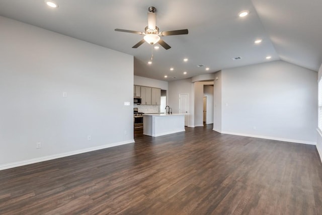 509 Oleander Loop, Buda, TX 78610 - unfurnished living room featuring a sink, baseboards, recessed lighting, dark wood finished floors, and a ceiling fan