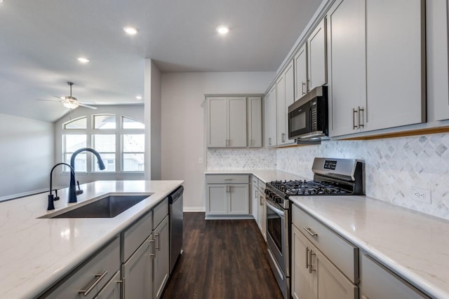 509 Oleander Loop, Buda, TX 78610 - kitchen featuring gray cabinetry, stainless steel appliances, decorative backsplash, and a sink