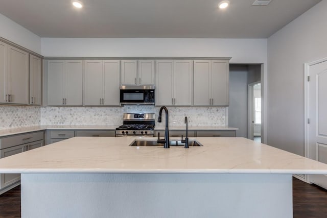 509 Oleander Loop, Buda, TX 78610 - kitchen featuring a sink, gray cabinets, stainless steel range with gas stovetop, dark wood-type flooring, and backsplash