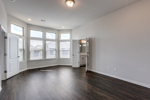 unfurnished living room with dark wood-type flooring