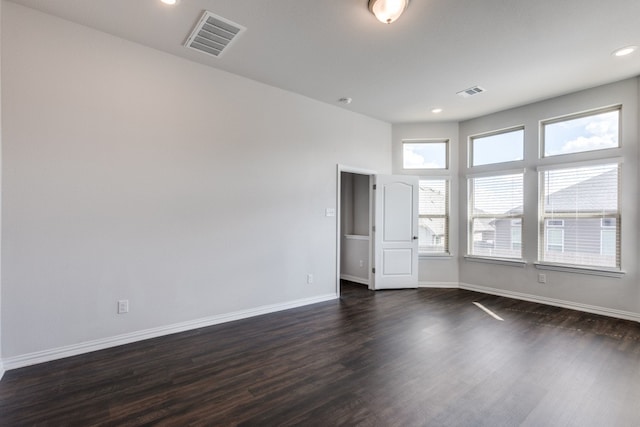 unfurnished room with dark hardwood / wood-style flooring