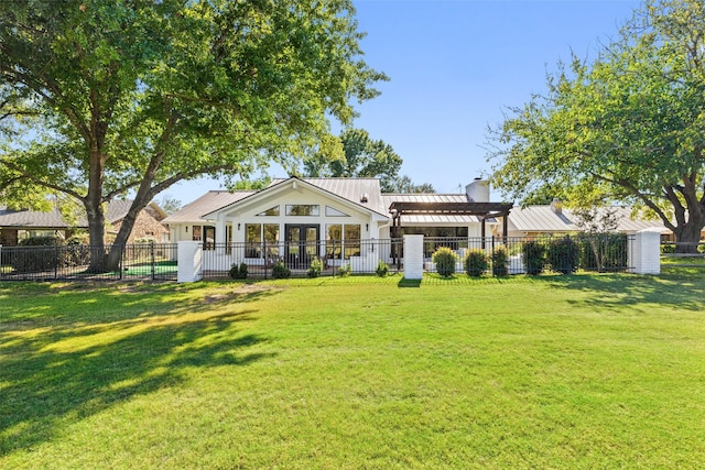 back of property featuring a lawn and a pergola