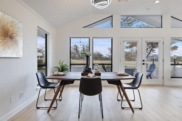 dining room featuring wooden ceiling, light hardwood / wood-style flooring, lofted ceiling, and french doors