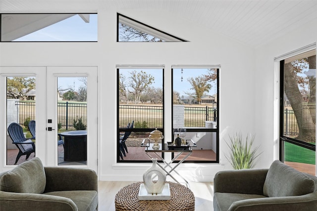 sunroom featuring wood ceiling, lofted ceiling, and french doors