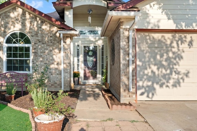 doorway to property with a garage