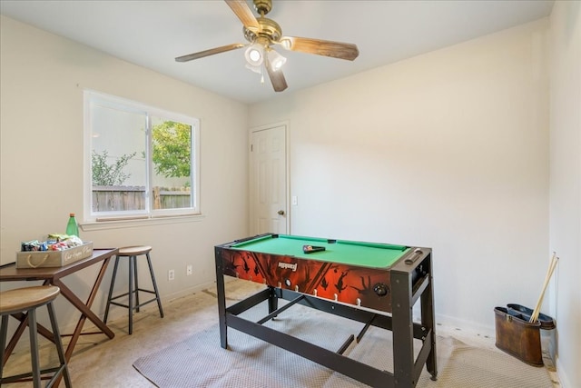 recreation room featuring light carpet and ceiling fan