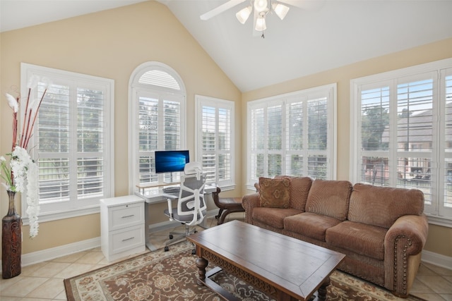 living room with light tile patterned floors, a wealth of natural light, lofted ceiling, and ceiling fan