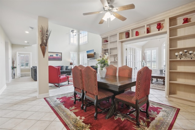 tiled dining space featuring built in features and ceiling fan