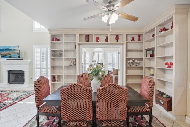 tiled dining area featuring ceiling fan and plenty of natural light