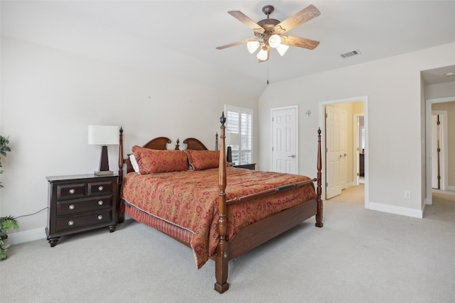 bedroom with light colored carpet, vaulted ceiling, and ceiling fan