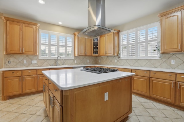 kitchen with island exhaust hood, a wealth of natural light, a center island, and stainless steel gas stovetop