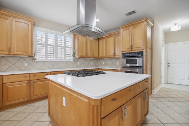 kitchen with island exhaust hood, light tile patterned floors, stainless steel appliances, and a kitchen island