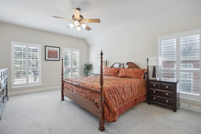 carpeted bedroom with ceiling fan and vaulted ceiling