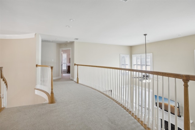 hall with light colored carpet