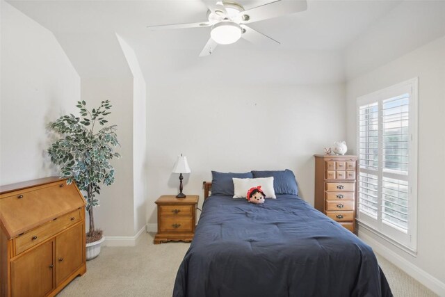 carpeted bedroom featuring vaulted ceiling and ceiling fan