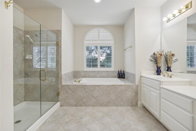 bathroom with tile patterned floors, vanity, and separate shower and tub