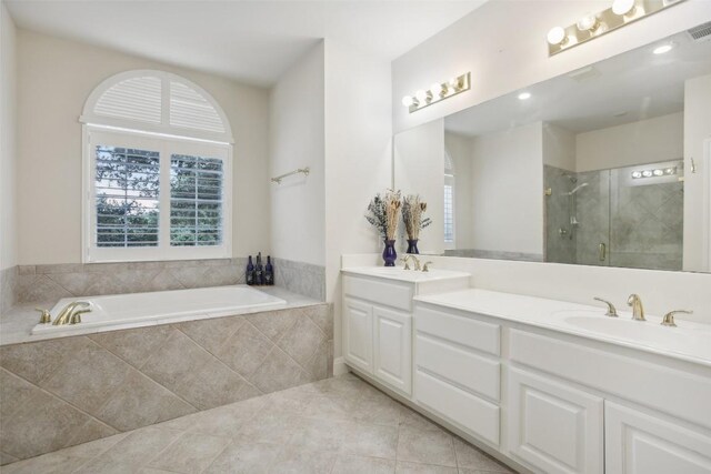 bathroom featuring tile patterned flooring, vanity, and separate shower and tub