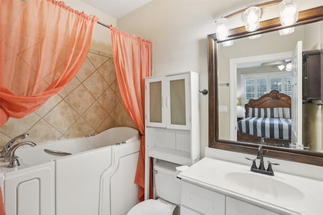 bathroom with vanity, tile walls, and toilet