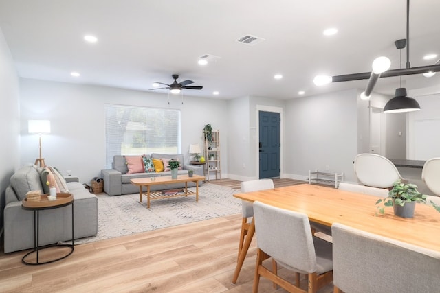 dining area with light hardwood / wood-style flooring and ceiling fan