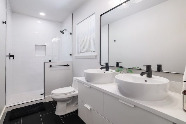 bathroom with vanity, toilet, an enclosed shower, and tile patterned floors