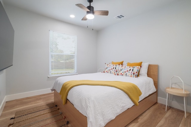 bedroom with ceiling fan and light wood-type flooring