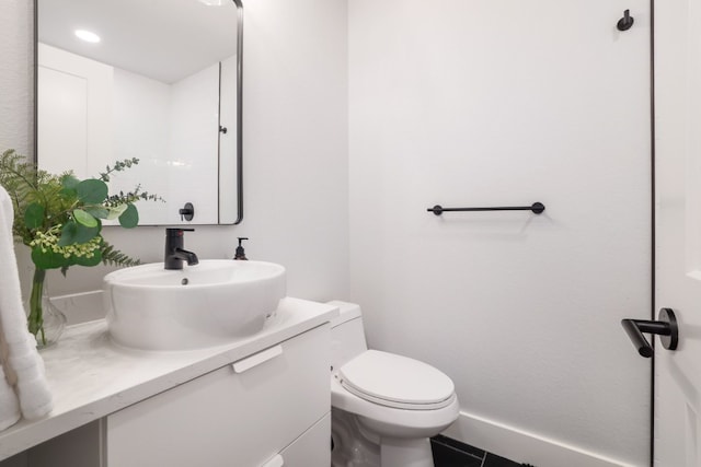 bathroom featuring vanity, tile patterned flooring, and toilet