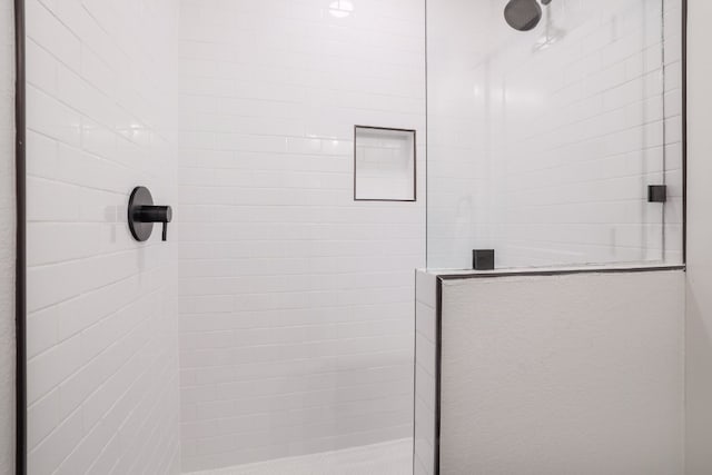 bathroom with a tile shower