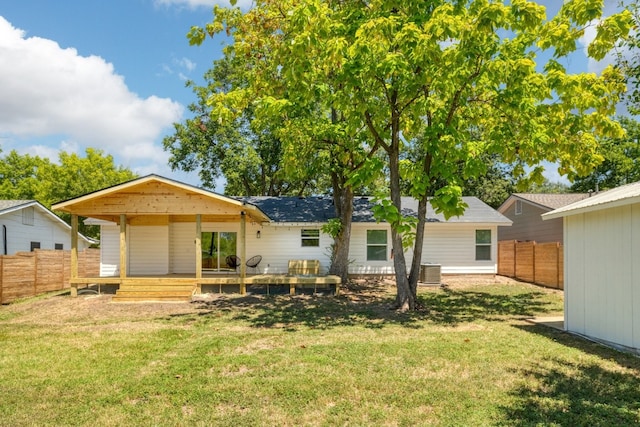 exterior space with central AC and a yard