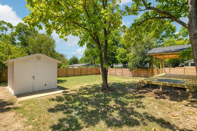 view of yard with a wooden deck and a shed