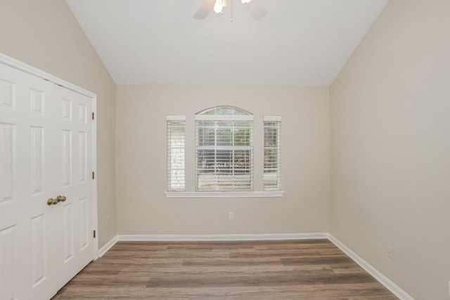 unfurnished room with hardwood / wood-style flooring, vaulted ceiling, and ceiling fan