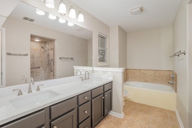 bathroom with a tub, tile patterned flooring, vanity, and toilet