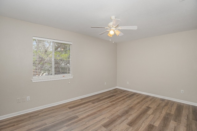 empty room featuring hardwood / wood-style floors and ceiling fan