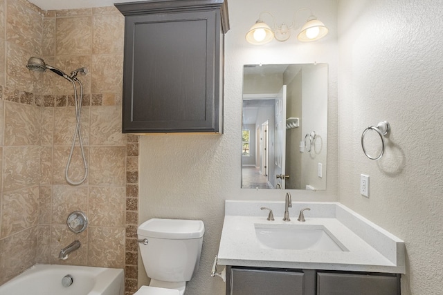 full bathroom with vanity, toilet, and tiled shower / bath