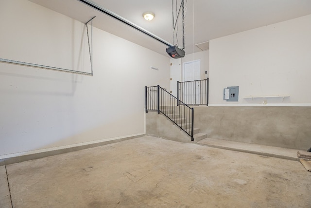 garage featuring electric panel and a garage door opener