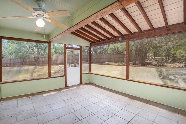 unfurnished sunroom featuring lofted ceiling with beams and ceiling fan