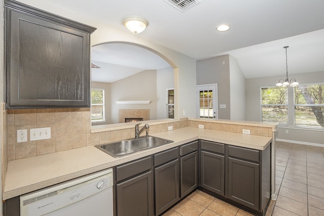 kitchen with dishwasher, a healthy amount of sunlight, vaulted ceiling, and sink