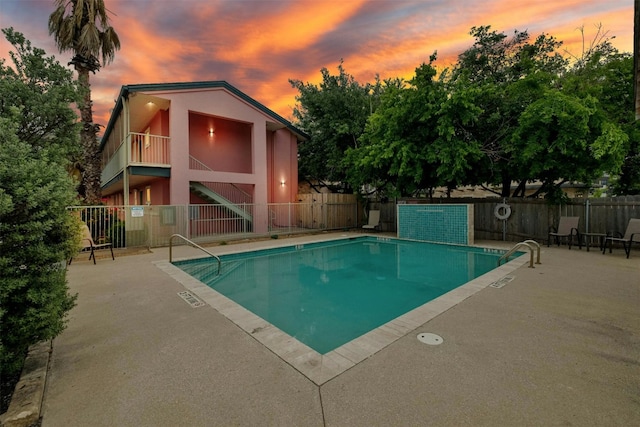 view of pool at dusk