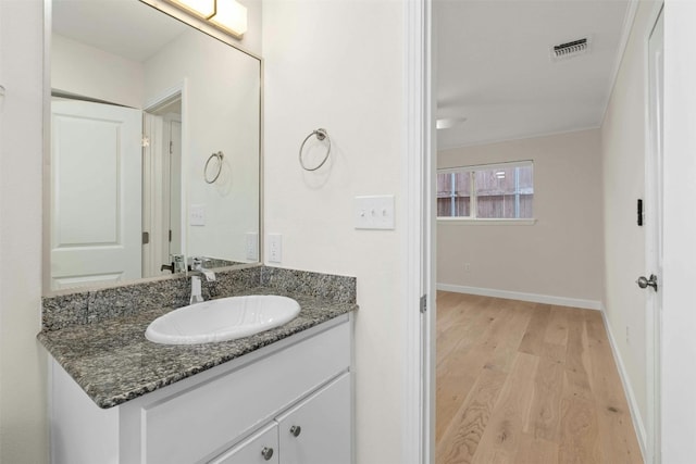 bathroom featuring hardwood / wood-style floors and vanity