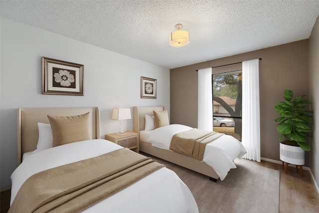 bedroom with wood-type flooring and a textured ceiling