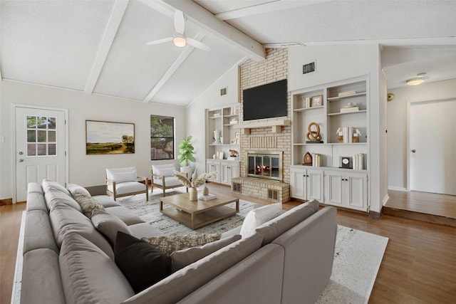 6700 Colina Ln, Austin, TX 78759 - living room with wood finished floors, a brick fireplace, ceiling fan, and built in features