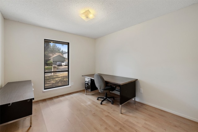 office area featuring light hardwood / wood-style floors and a textured ceiling