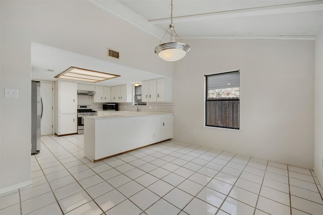 kitchen with lofted ceiling, light tile patterned floors, kitchen peninsula, white cabinetry, and stainless steel appliances