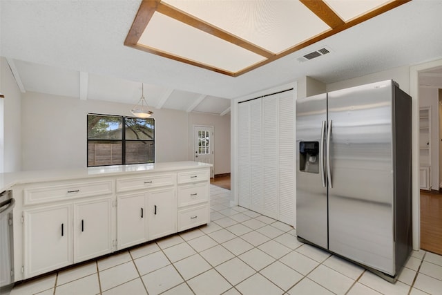 kitchen featuring white cabinets, pendant lighting, light tile patterned floors, stainless steel refrigerator with ice dispenser, and vaulted ceiling