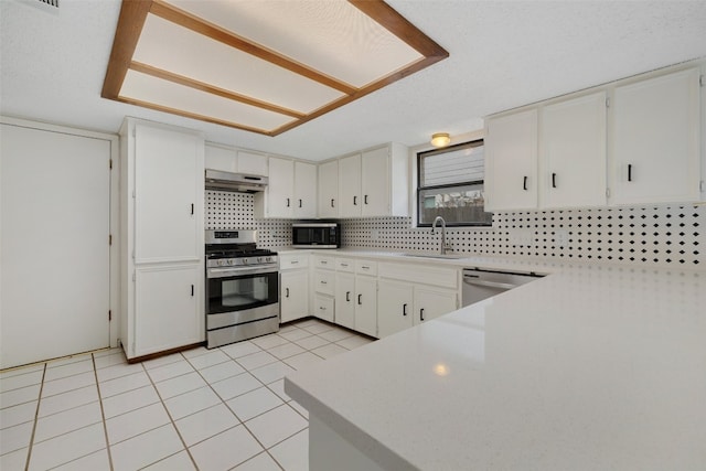 kitchen featuring decorative backsplash, stainless steel appliances, white cabinets, and sink